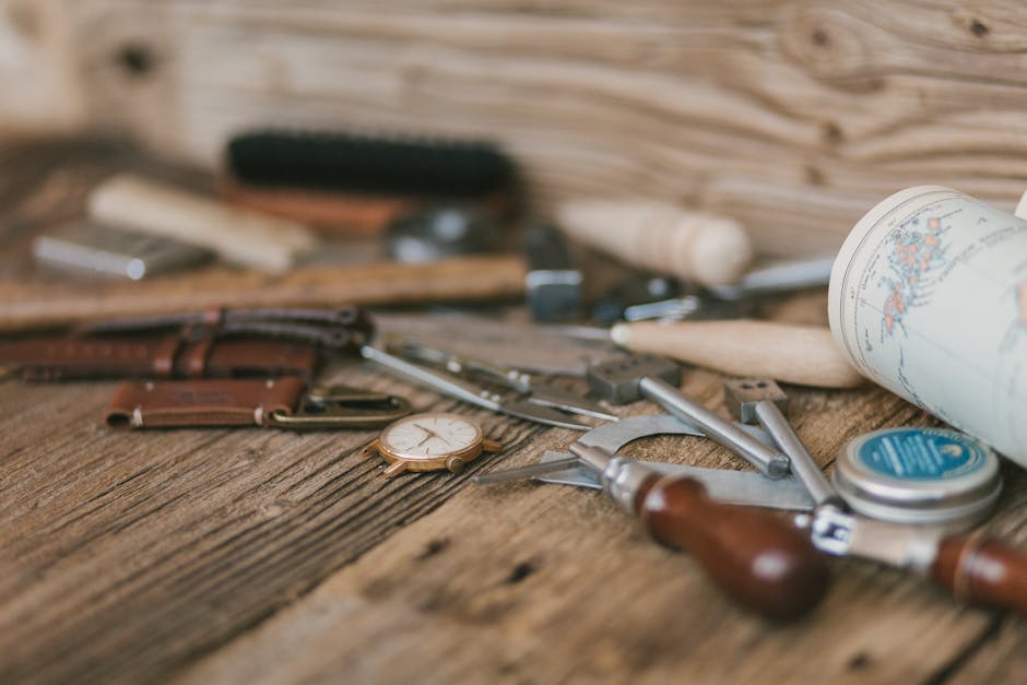 Close-up of artisan tools on a wooden workbench, showcasing craftsmanship and creativity.